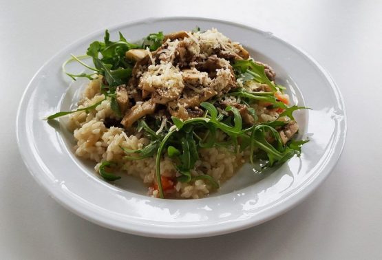 Risotto mit Salsiccia Wildschweinssalami und Champignons sowie Rucola ist eine deftige, italienische Speise und einfach zu kochen. Wenn man auch ein wenig Geduld mitbringen sollte.