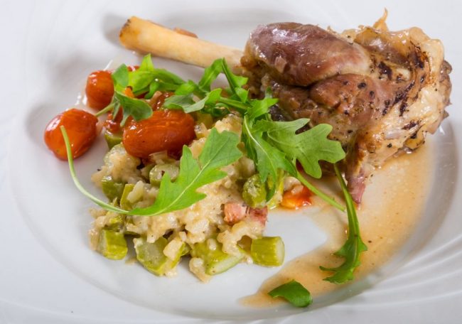 Lammhaxe mit Risotto und Rucola